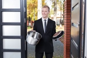 Door to door salesman selling pots and pans