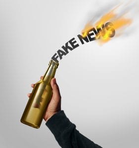 Fake news danger concept and hoax journalistic reporting as a person throwing a molotov cocktail shaped as text as false media reporting risk metaphor with 3D illustration elements.